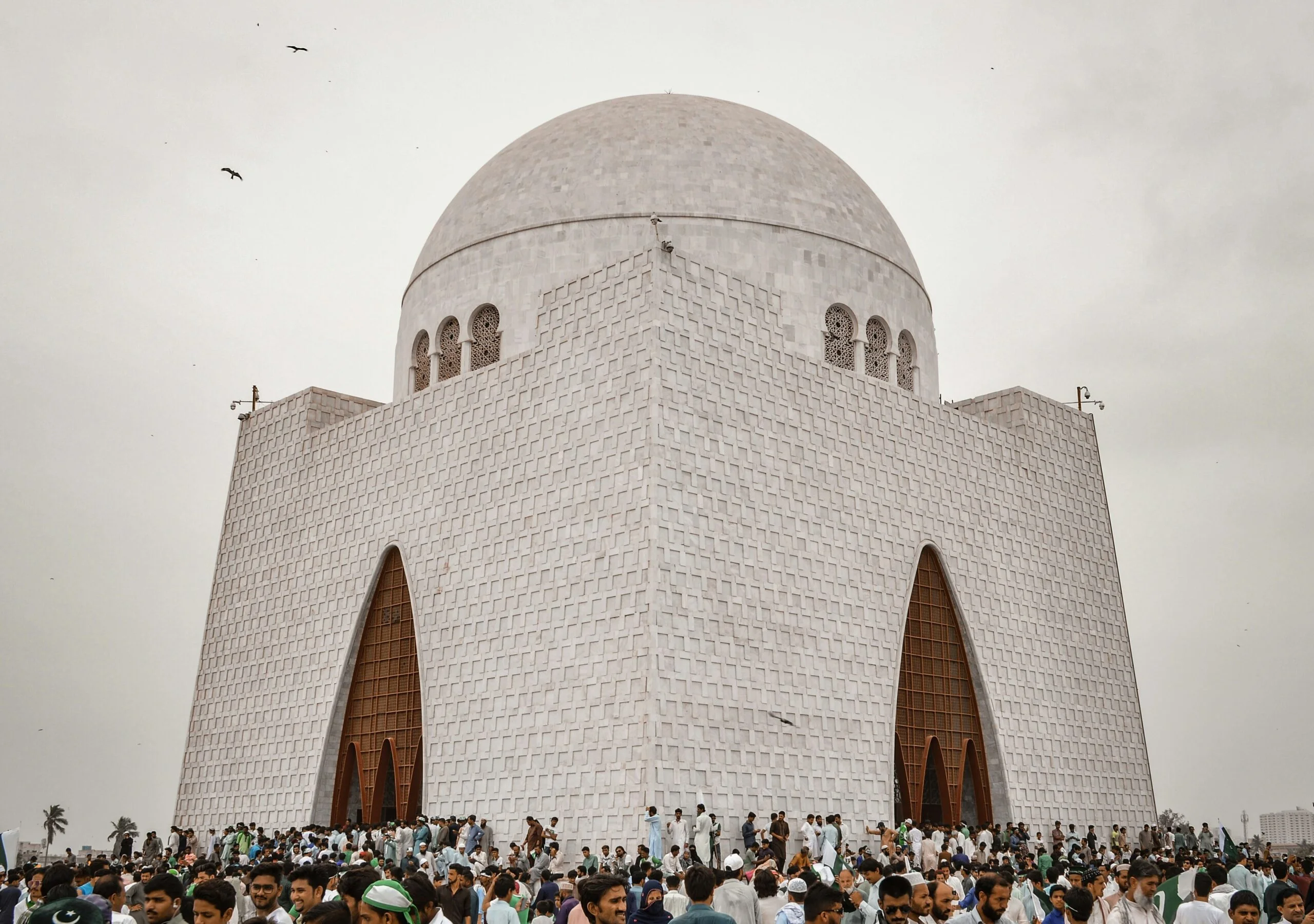 "Mazar-e-Quaid in Karachi near NEOM Rent a Car offices, a prominent landmark surrounded by visitors in the city.